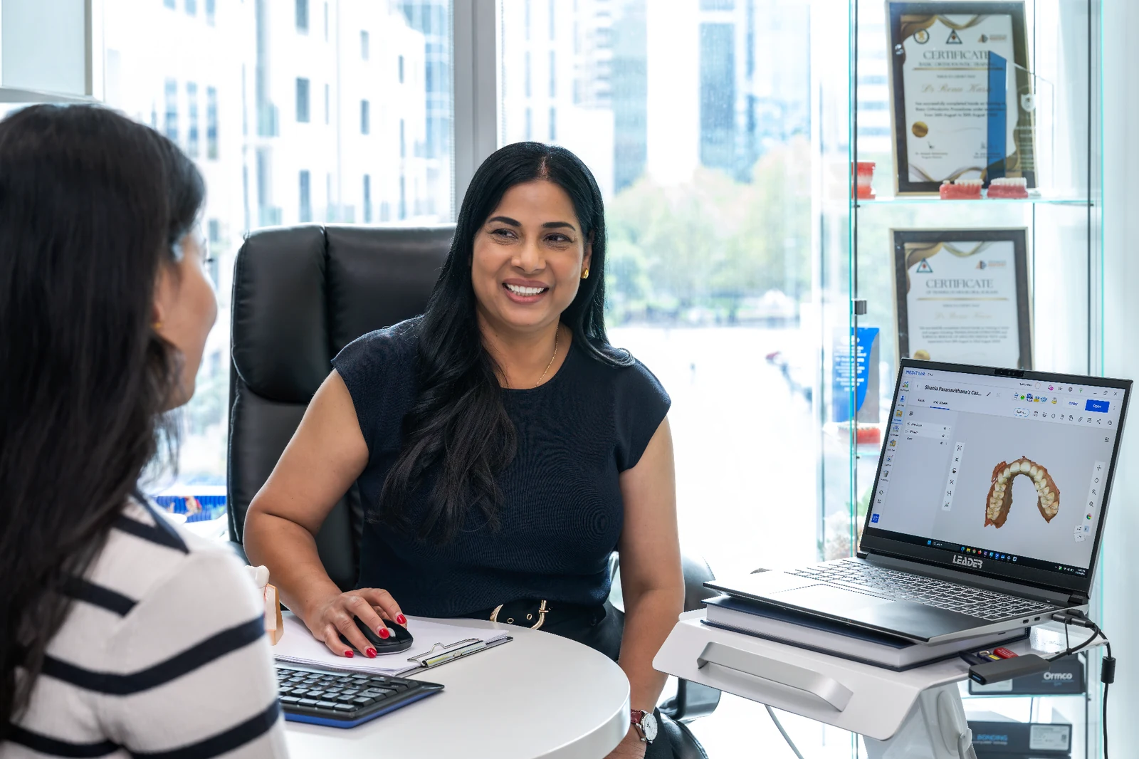 Dr Renu Karn reviewing a digital treatment plan with a patient