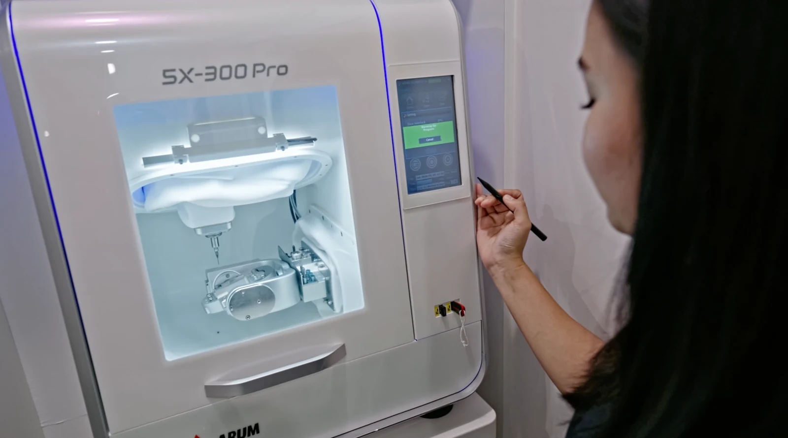 A dentist operating the in-house ceramic milling machine
