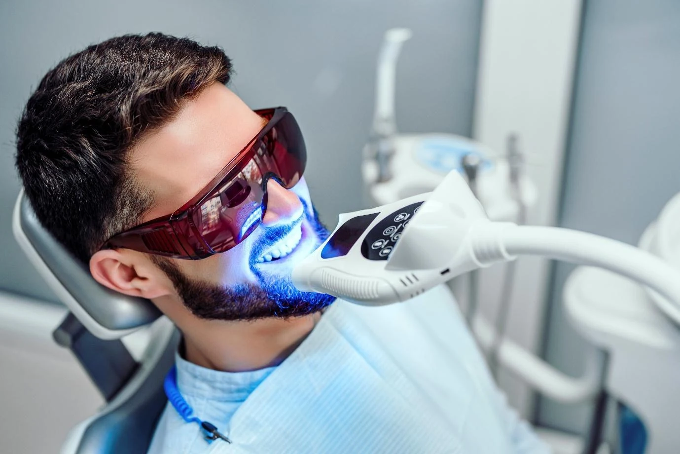 A patient wearing protective glasses during ZOOM whitening