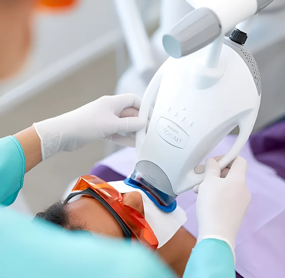 A patient receiving an in-chair Philips ZOOM whitening treatment