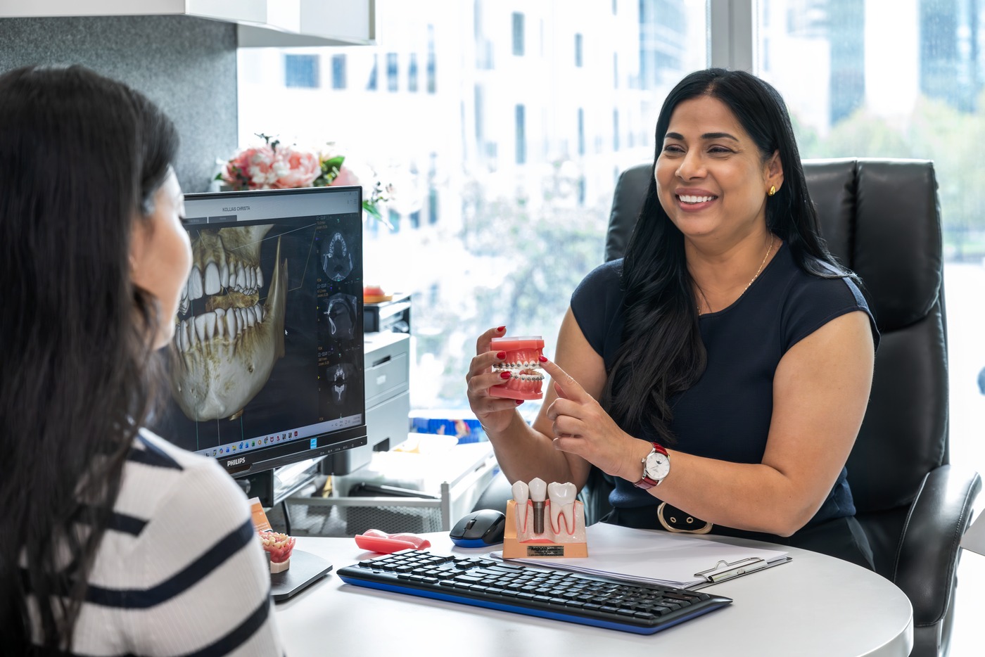 Dr Renu Karn explaining a 3D CBCT scan to a patient